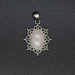 Detailed view of pink natural stone pendant with intricate silver openwork border