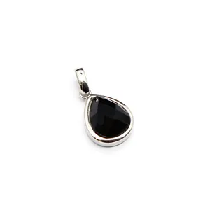 Detailed macro view of a faceted black gemstone pear-shaped pendant in silver setting