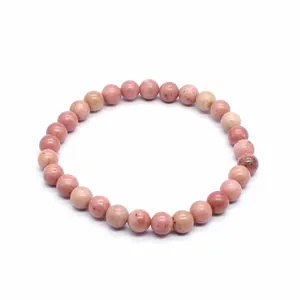Detail view of a 6mm round pink natural stone bead bracelet for women on white background