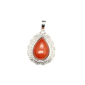 Close-up of a teardrop-shaped gemstone pendant with intricate silver filigree edging.