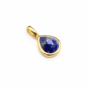 Close-up of a faceted blue lapis lazuli teardrop pendant in a gold-plated setting