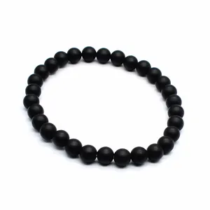 Close-up of 6mm matte black round stone bead bracelet showing smooth matte texture