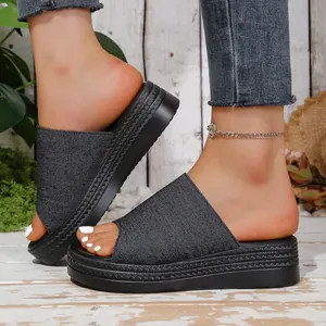 Detailed side view of women's denim platform slide sandals with textured thick sole
