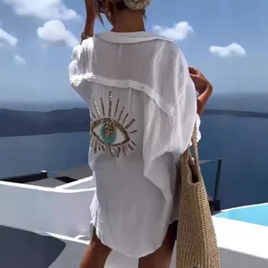 Oversized white cotton linen shirt with sequined evil eye graphic on back view