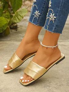 Detailed view of gold metallic square toe flat slide sandals for women