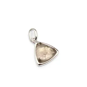 Close-up of a triangular natural stone pendant with a polished silver frame detail