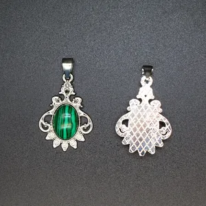 Detailed macro view showing the front and back of a malachite stone silver pendant