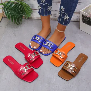 Group display of flat square-toe slide sandals with gold chain in multiple colors