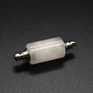 Macro view of a cylindrical pink crystal essential oil bottle pendant with metal caps