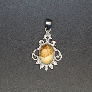 Vintage silver-toned filigree pendant featuring a natural oval earthy-toned stone.
