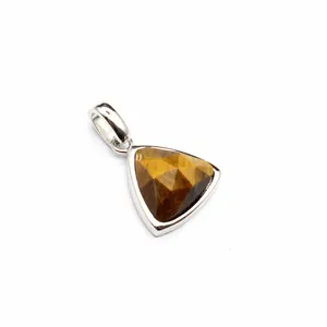 Close-up of a faceted triangular tiger eye stone pendant in a silver setting