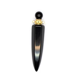Macro view of black onyx hexagonal aromatherapy bottle pendant with gold hardware