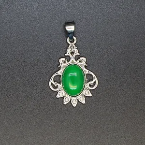 Close-up of vintage silver pendant featuring an oval green malachite stone inlay