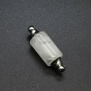 Macro detail of cylindrical white quartz perfume bottle pendant with silver finish