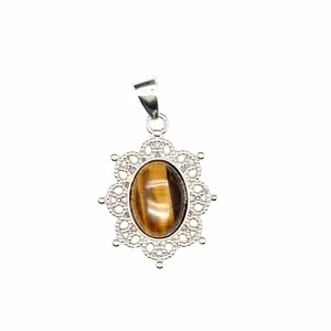 Close-up detail of tiger's eye stone pendant with intricate silver filigree frame