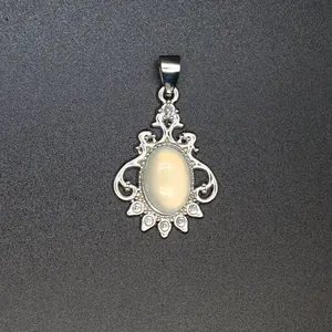 Detailed view of an elegant vintage silver pendant with an oval white gemstone inlay