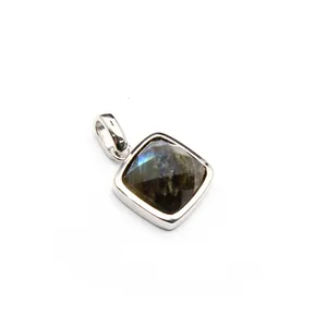 Detailed macro view of a faceted square natural stone pendant with blue iridescence.