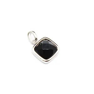 Close-up macro view of a square faceted black gemstone pendant in silver setting