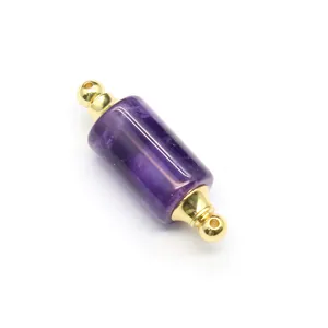 Close-up of cylindrical amethyst essential oil bottle pendant with gold accents
