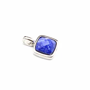 Close-up view of a square faceted blue natural stone pendant in a silver bezel setting