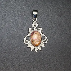 Vintage silver-plated pendant featuring a natural pink stone with white crystal accents