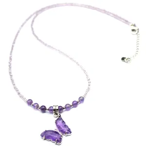 Close-up of a natural amethyst butterfly pendant with purple beaded chain jewelry