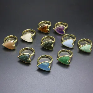 Detail showing ten vintage heart-shaped rings with various natural stone inlays