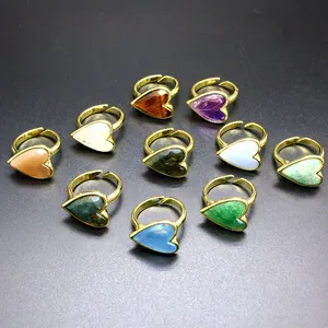 Detailed view of vintage gold heart-shaped rings with various colorful natural gemstones