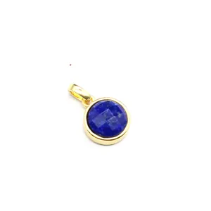 Close-up of a faceted blue natural stone pendant in a gold-plated circular frame