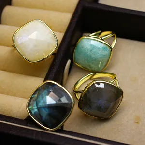 Detalle de primer plano de anillos de piedra natural tallada en un joyero café chic