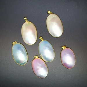 Macro view of oval natural mother of pearl shell pendants featuring iridescent colors