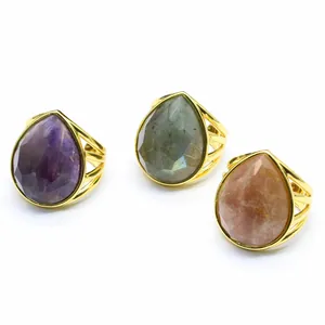 Collection of three gold rings with teardrop-shaped natural crystal stones
