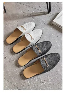 Detail view of men's stylish quilted horsebit mule loafers in white and black colors