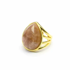 Macro view of teardrop-shaped peach quartz stone on a multi-strand gold-plated ring band
