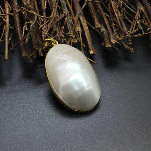 Macro view of a large iridescent oval white mother of pearl shell pendant necklace
