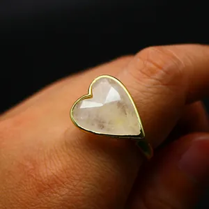 Close-up of a vintage-style gold ring featuring a heart-shaped faceted natural stone