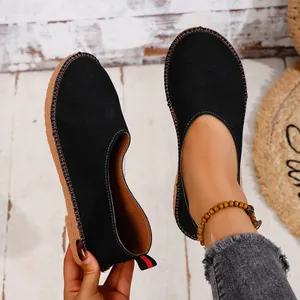 Detailed view of black vintage round-toe slip-on flats with visible stitching and soft upper