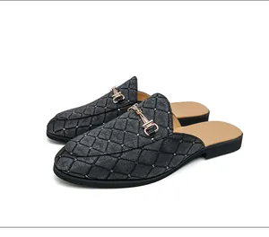 Close-up of men's British style quilted backless loafers with golden horsebit buckle