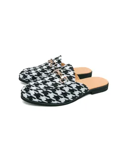 Angle view of men's breathable houndstooth mule loafers with gold buckle detail.
