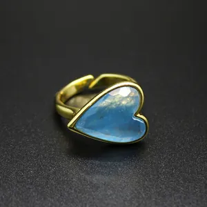 Detailed close-up of a vintage gold ring featuring a faceted blue heart-shaped natural stone