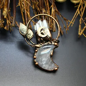 Detailed view of a vintage moon pendant with raw quartz crystals and copper leaf accents.
