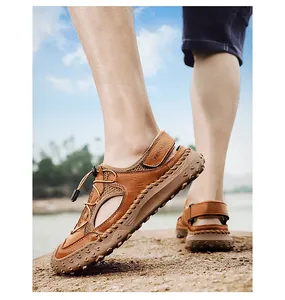 Close-up of men's brown leather casual sandals worn outdoors on a natural rocky surface.