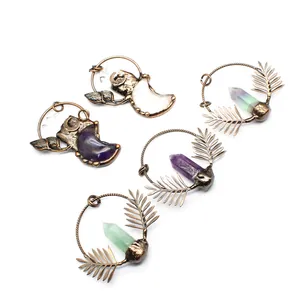 Antique bronze crystal pendants featuring moon and leaf designs in varied stones