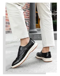 Close-up of stylish black leather brogue shoes with thick white soles on model feet.