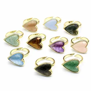 Collection of ten adjustable gold rings featuring colorful heart-shaped natural stones