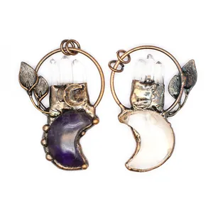 Close-up detail of retro copper pendants with natural amethyst moon and crystals