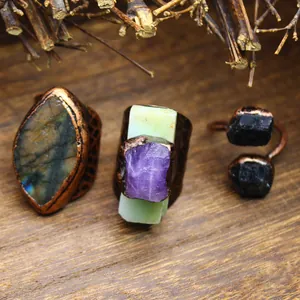 Detailed view of vintage copper rings set with natural amethyst and labradorite stones.