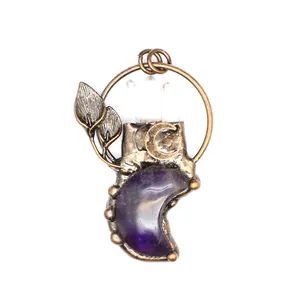 Vintage amethyst moon pendant with bronze leaf details and clear crystal points.