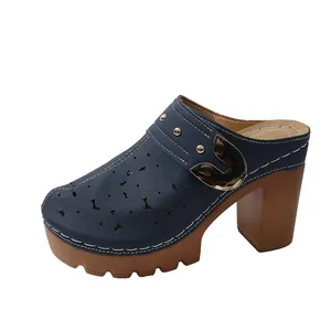 Detailed view of navy blue hollow-out mules with gold buckle and platform heel