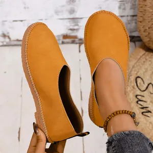 Close-up of vintage mustard yellow soft leather flats with round toe and Mori style